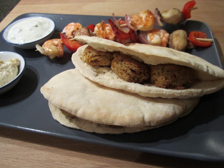Falafel Falafel with pitta bread, tzatziki, hummous and griddled vegetable and prawn skewers