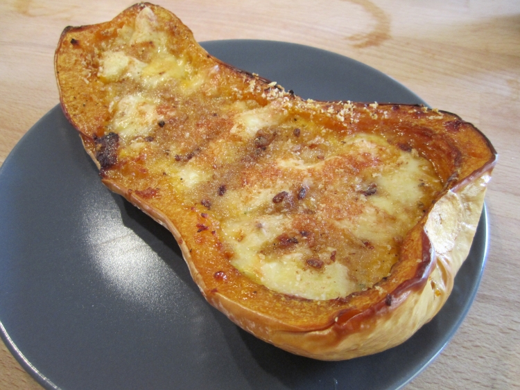 Stuffed butternut squash with creme fraiche, herbs and cheese
