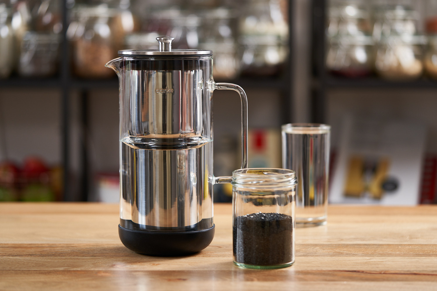 Small Aarke water purifier and a jar of activated carbon