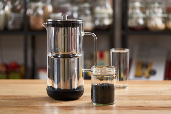 Small Aarke water purifier and a jar of activated carbon