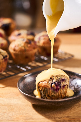 Bird's custard (made from powder) poured over a blueberry and raspberry muffin