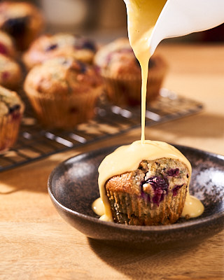 Bird's custard (made from powder) poured over a blueberry and raspberry muffin