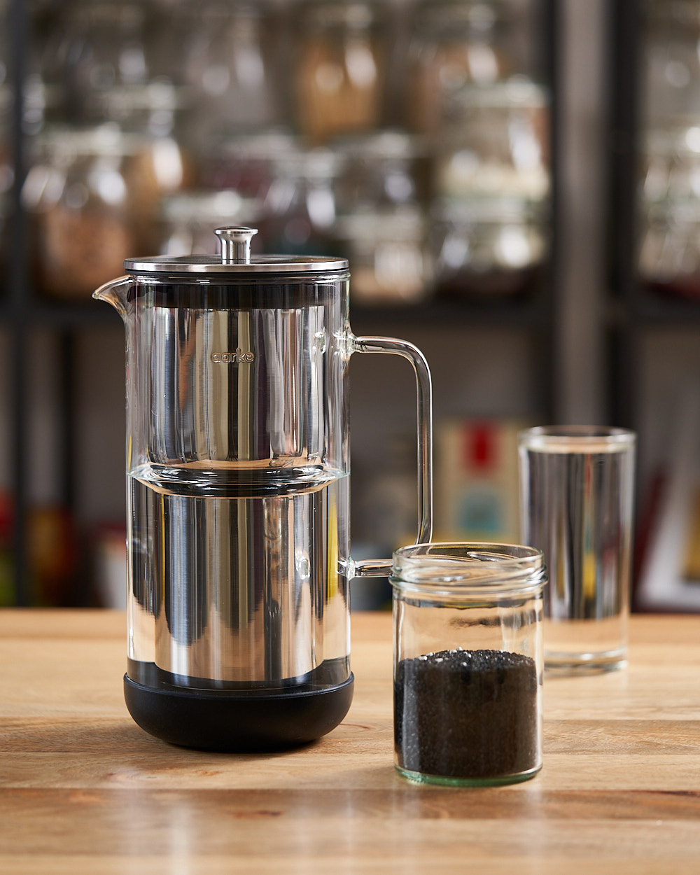 Small Aarke water purifier and a jar of activated carbon